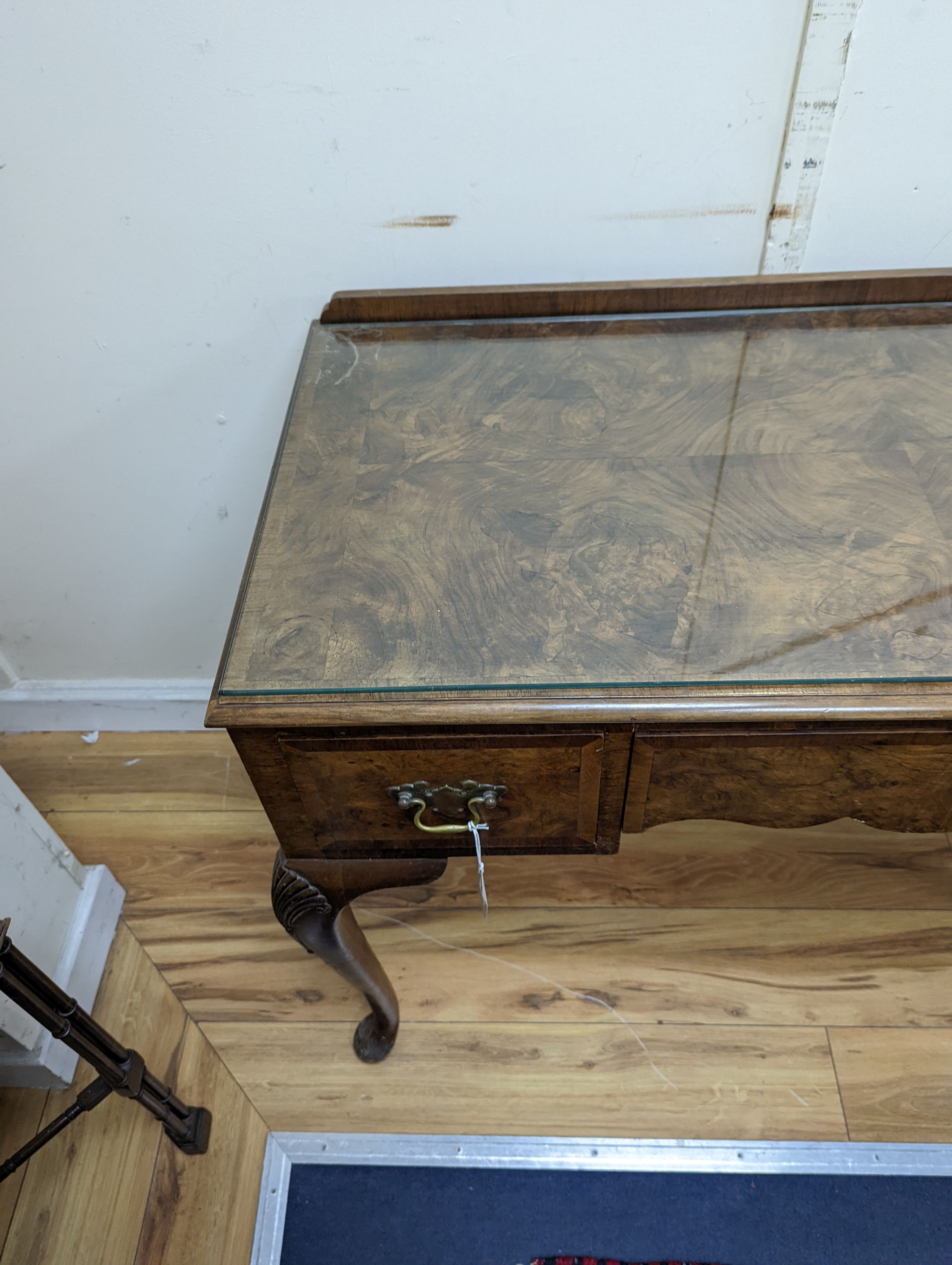 A 1920's Queen Anne revival walnut kneehole dressing table, length 106cm, depth 50cm, height 77cm